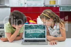 Kids looking at a computer with school icons on screen