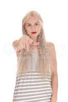 Serious woman pointing finger at camera