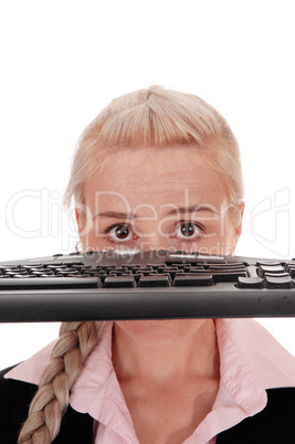Woman holding the keyboard over her face