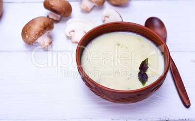 Mushroom creamy soup in a clay brown plate