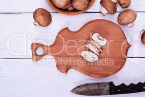 Sliced mushrooms on a wooden  kitchen board