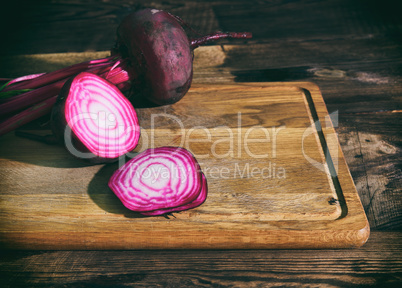 Sliced red beet on a wooden kitchen board