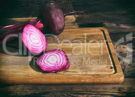 Sliced red beet on a wooden kitchen board