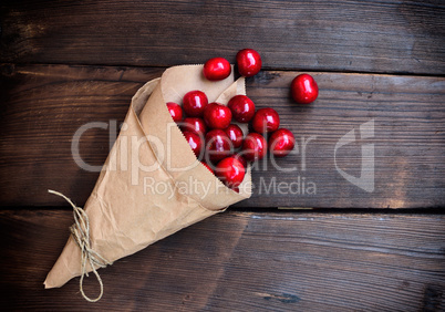 Ripe red cherry in a paper bag