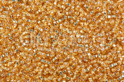 Yellow corn seed beads background.