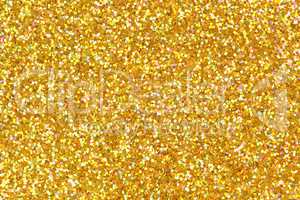 Detailed texture of glittering golden dust surface.