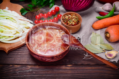 Traditional Ukrainian borsch in a round brown plate