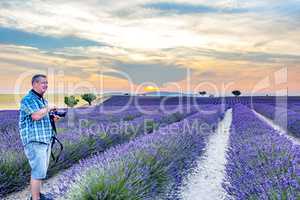 Photographer in blooming lavender field