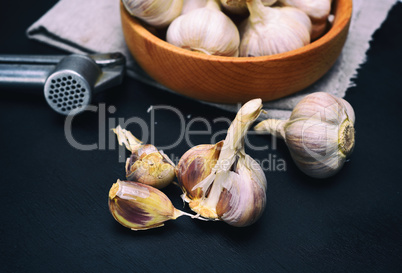 Fresh garlic on a black wooden board