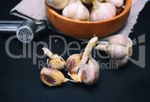 Fresh garlic on a black wooden board