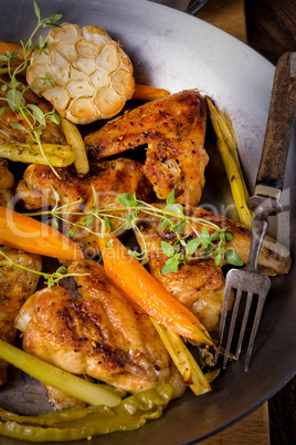 Grilled chicken wings with caramelized carrots