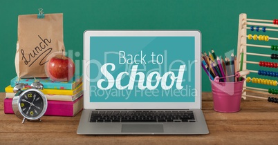 Computer on a school table with back to school text on screen