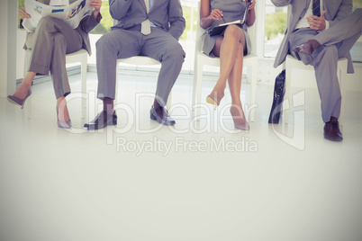 Business people sitting on chairs