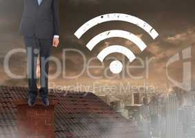 Wi-fi icon and  Businessman standing on Roof with chimney and cloudy city