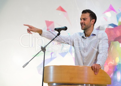 Businessman on podium speaking at conference with colorful background