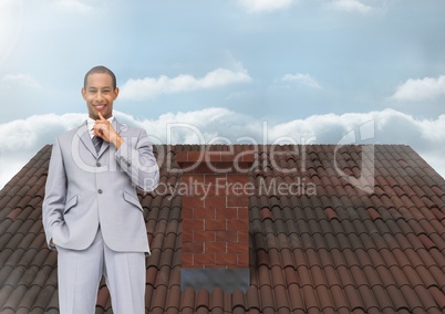Businessman standing on Roof with chimney and sky