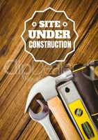 Website under construction text against tools photo