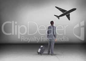 Businessman with travel bag looking up with plane icon