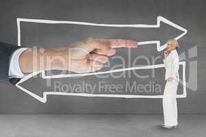 Hand pointing at business woman against grey background with arrows