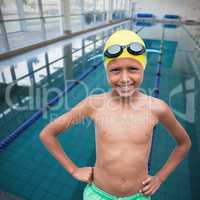 Composite image of portrait of cheerful shirtless boy wearing swimming goggles and cap