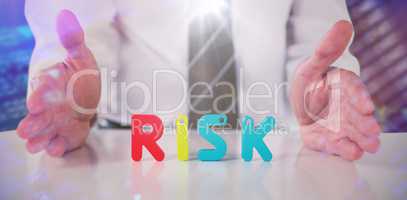 Composite image of mid section of businessman with colorful risk text