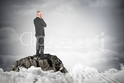 Composite image of thoughtful businessman standing back to camera