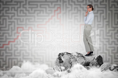 Composite image of thoughtful businesswoman standing