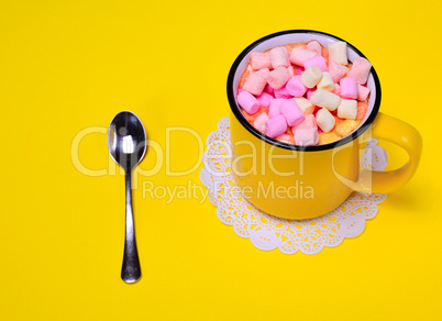 Yellow cup with multi-colored marshmallow