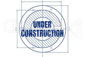 Under construction text against blueprint