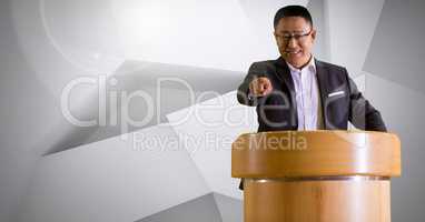 Businessman on podium speaking at conference with minimal background
