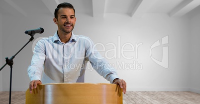 Businessman on podium speaking at conference in room