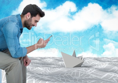 Businessman on phone in sea of documents under sky clouds with paper boat