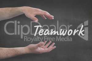 Hands interacting with teamwork business text against grey background