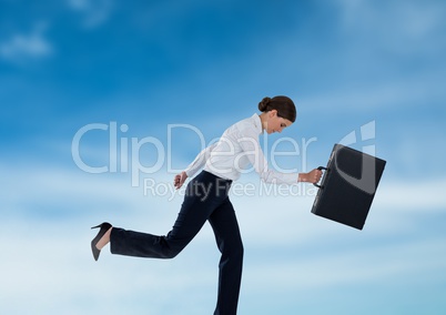 Businesswoman running with briefcase in the sky