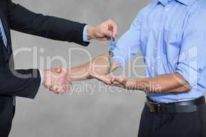 Business man giving keys and shaking hands