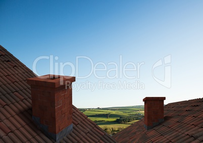 Roofs with chimney and green country landscape