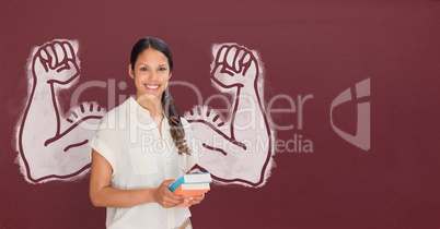 Happy student woman with fists graphic standing against red blackboard