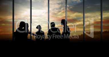 Business people at a meeting silhouettes against building