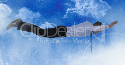 Businessman flying in blue sky