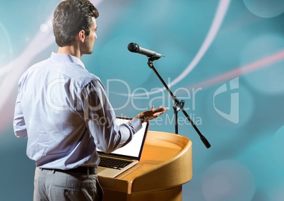 Businessman on podium speaking at conference with abstract background
