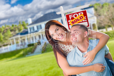 Playful Excited Military Couple In Front of Home with Sold Real