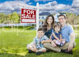 Young Family With Children In Front of Custom Home and For Sale