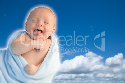 Beautiful Laughing Baby Boy Wrapped in His Blanket With A Blue S