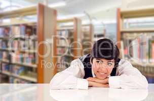 Young Female Mixed Race Student Daydreaming In Library Looking T