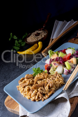 Meat strips in spicy sweet and sour sauce and green salad