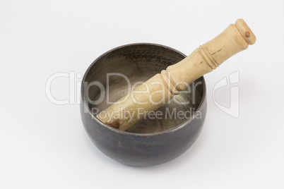 A singing bowl, with a stick in it.
