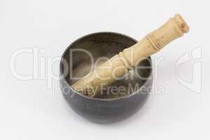 A singing bowl, with a stick in it.
