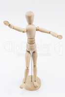 A wooden mannequin with open arms.