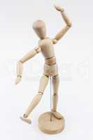 A wooden mannequin in a dance pose.