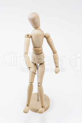 A wooden mannequin standing.